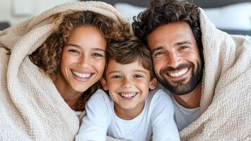 A family smiling under a blanket photo