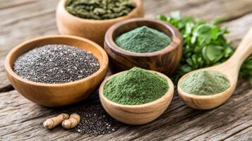 Green powders and herbs in wooden bowls photo