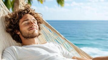 A man is relaxing in a hammock on the beach photo