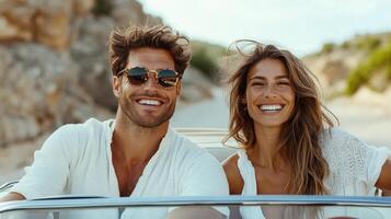 A man and woman in a convertible car on the beach photo