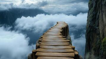 A wooden walkway leads to a mountain with clouds photo