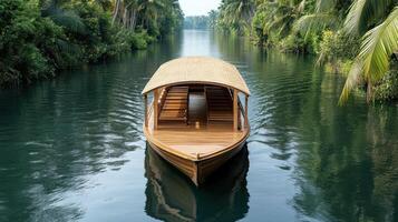 A boat is traveling down a river through a lush green area photo