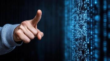 A hand pointing at a binary code photo