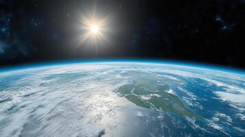 The earth from space with the sun shining photo