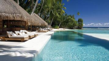 A resort pool with lounge chairs and thatched huts photo