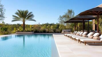 The pool at the resort is surrounded by lounge chairs photo
