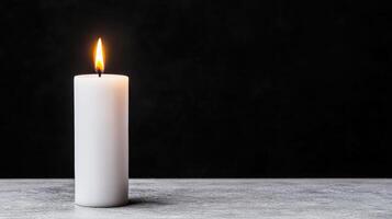 A single white candle on a table photo