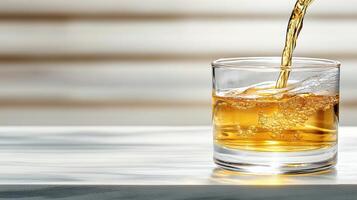A glass of whiskey being poured into a glass photo
