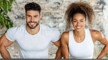 A man and woman are smiling while standing in front of a table photo