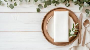 White napkin on wooden plate with eucalyptus leaves photo