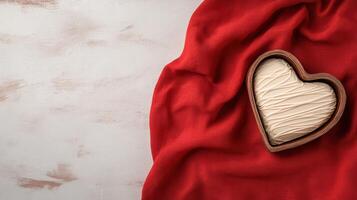 A heart shaped chocolate box on a red cloth photo