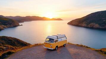 A camper van is parked on a road overlooking the ocean photo