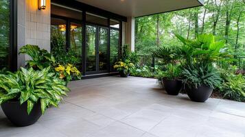 A large patio with plants and a glass door photo