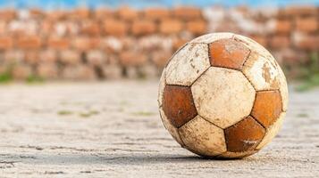 An old soccer ball on the ground photo