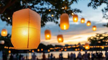 Paper lanterns hanging from a tree at dusk photo