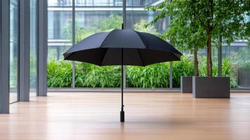 An umbrella is standing in front of a large window photo