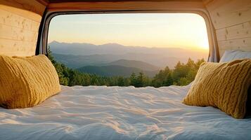 A bed with yellow pillows and a view of mountains photo