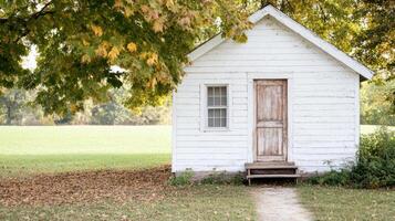A small white house with a door and a path photo