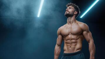 A man with no shirt on standing in front of a blue background photo