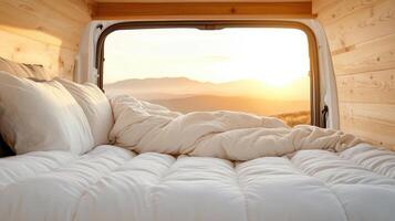 A bed in a van with a view of mountains photo