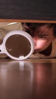 vertical Man inspecting floor with magnifying glass underneath furniture video