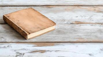 An old book on a wooden table photo
