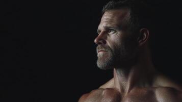 A man with no shirt on looking off into the distance photo