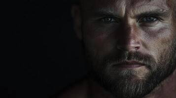A man with a beard and a beard staring into the camera photo
