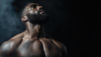 A man with a tattooed chest and chest is standing in smoke photo