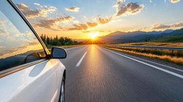 A car driving down the road at sunset photo