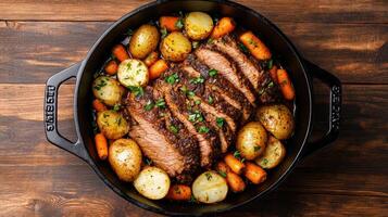 A pan filled with meat, potatoes and carrots photo
