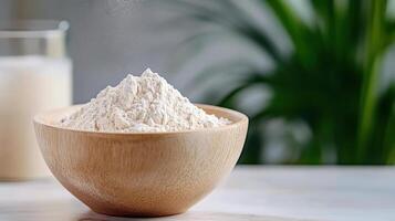 A bowl of flour and a glass of milk photo