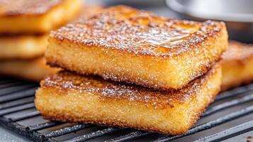 A stack of square pancakes on a cooling rack photo