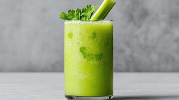 A green drink with celery and a green garnish photo