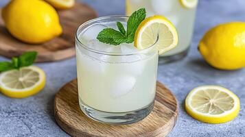 Two glasses of lemonade with mint leaves on top photo