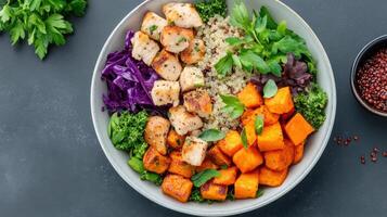 A bowl of food with chicken, vegetables and other ingredients photo