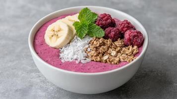 A bowl of smoothie with berries, bananas, oats and granola photo