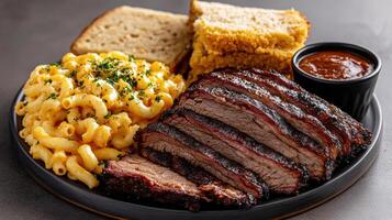 A plate with a steak, macaroni and cheese and bread photo