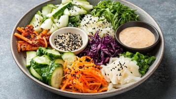 A bowl of vegetables and salad with sesame dressing photo