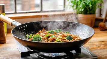 A wok with food cooking on top of a stove photo