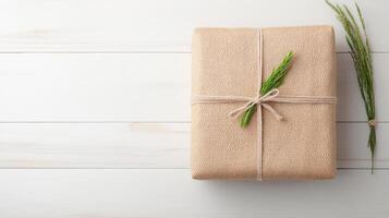 Gift wrapped in brown paper with twine on white wooden background photo