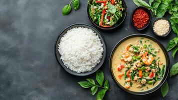 Thai curry with rice and vegetables on a dark background photo