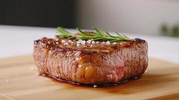 A piece of steak on a wooden cutting board photo
