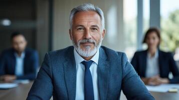 A man with a beard and suit in front of a group of people photo