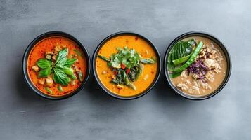 Three bowls of soup with different colors photo