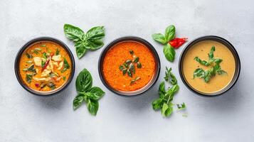 Three bowls of soup with different ingredients photo