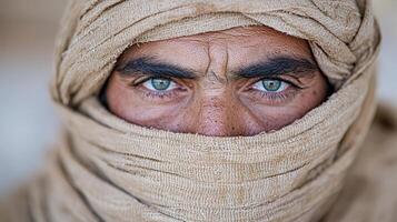 A man with blue eyes in a scarf photo