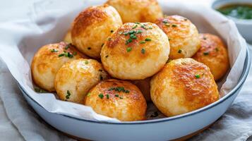 A bowl filled with bread rolls and herbs photo