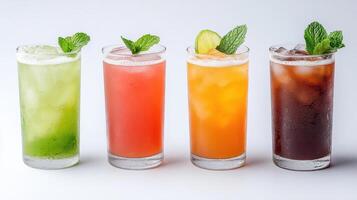 Four different colored drinks in glasses on a white background photo