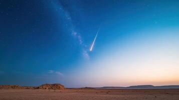 A comet is seen in the sky over a desert photo